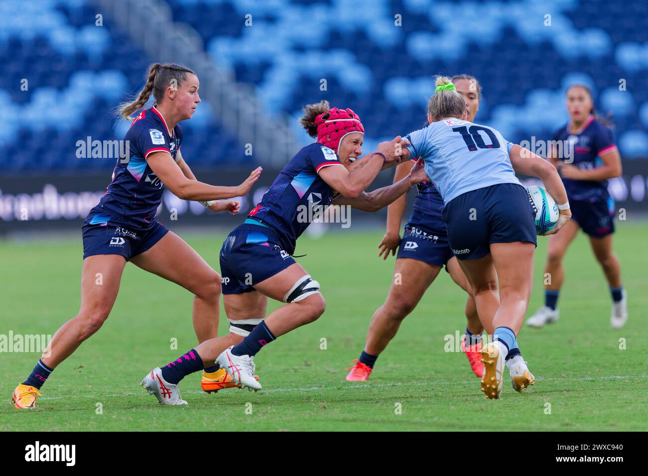 Sydney, Australia. 29th Mar, 2024. Arabella McKenzie of the Waratahs is tackled by Melanie Kawa of the Rebels during the Super Rugby Women's 2024 Rd3 match between the Waratahs and the Rebels at Allianz Stadium on March 29, 2024 in Sydney, Australia Credit: IOIO IMAGES/Alamy Live News Stock Photo