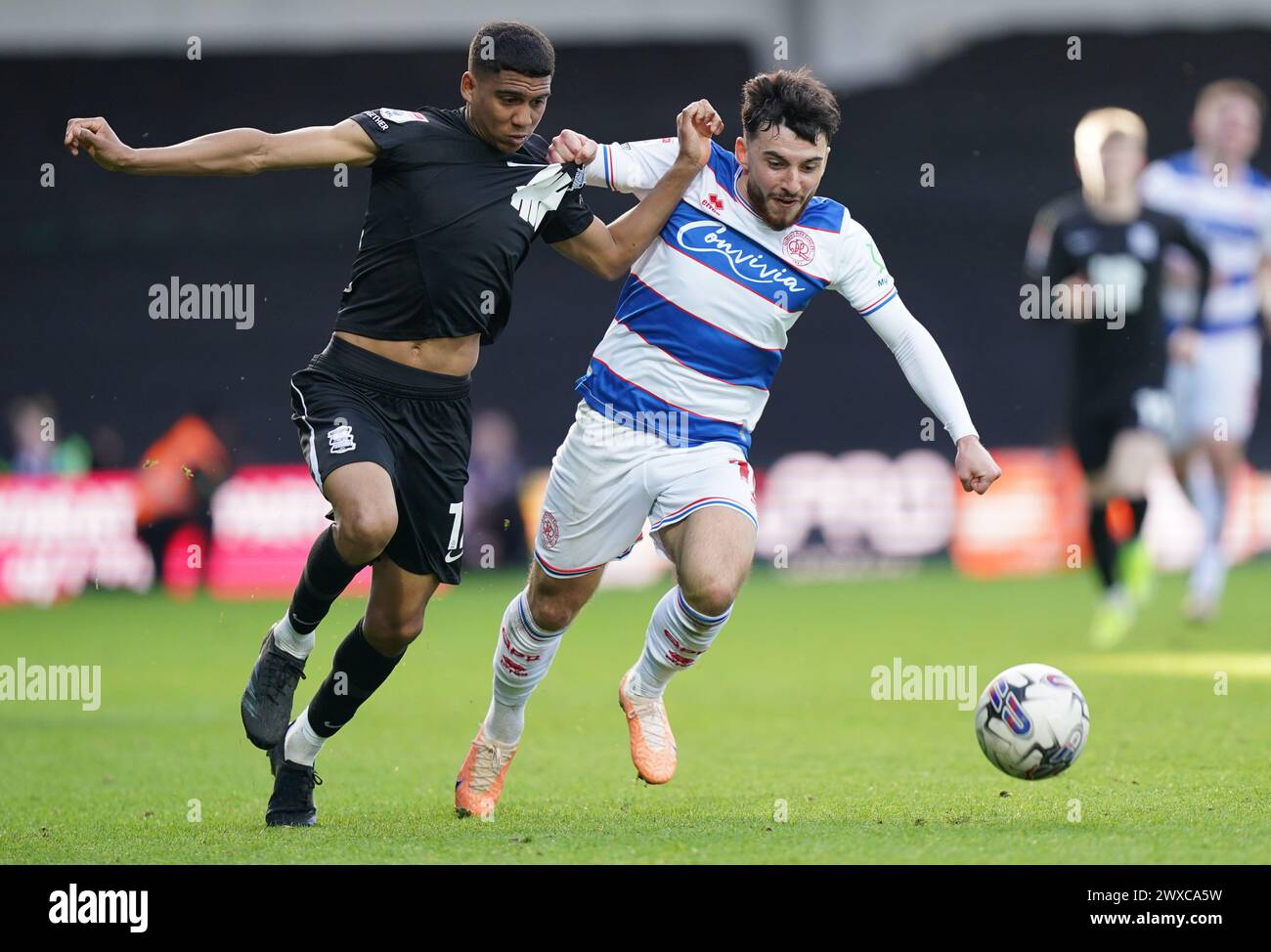 LONDON, ENGLAND - MARCH 29: Cody Drameh of Birmingham City and Ilias Chair of Queens Park Rangers battling for the ball during the Sky Bet Championship match between Queens Park Rangers and Birmingham City at Loftus Road on March 29, 2024 in London, England.(Photo by Dylan Hepworth/MB Media) Stock Photo