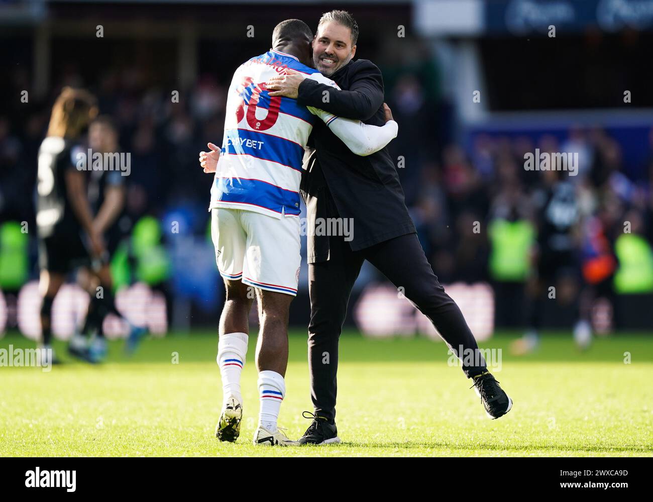 LONDON, ENGLAND - MARCH 29: Sinclair Armstrong of Queens Park Rangers and Martí Cifuentes, manager of Queens Park Rangers celebrating after the Sky Bet Championship match between Queens Park Rangers and Birmingham City at Loftus Road on March 29, 2024 in London, England.(Photo by Dylan Hepworth/MB Media) Stock Photo