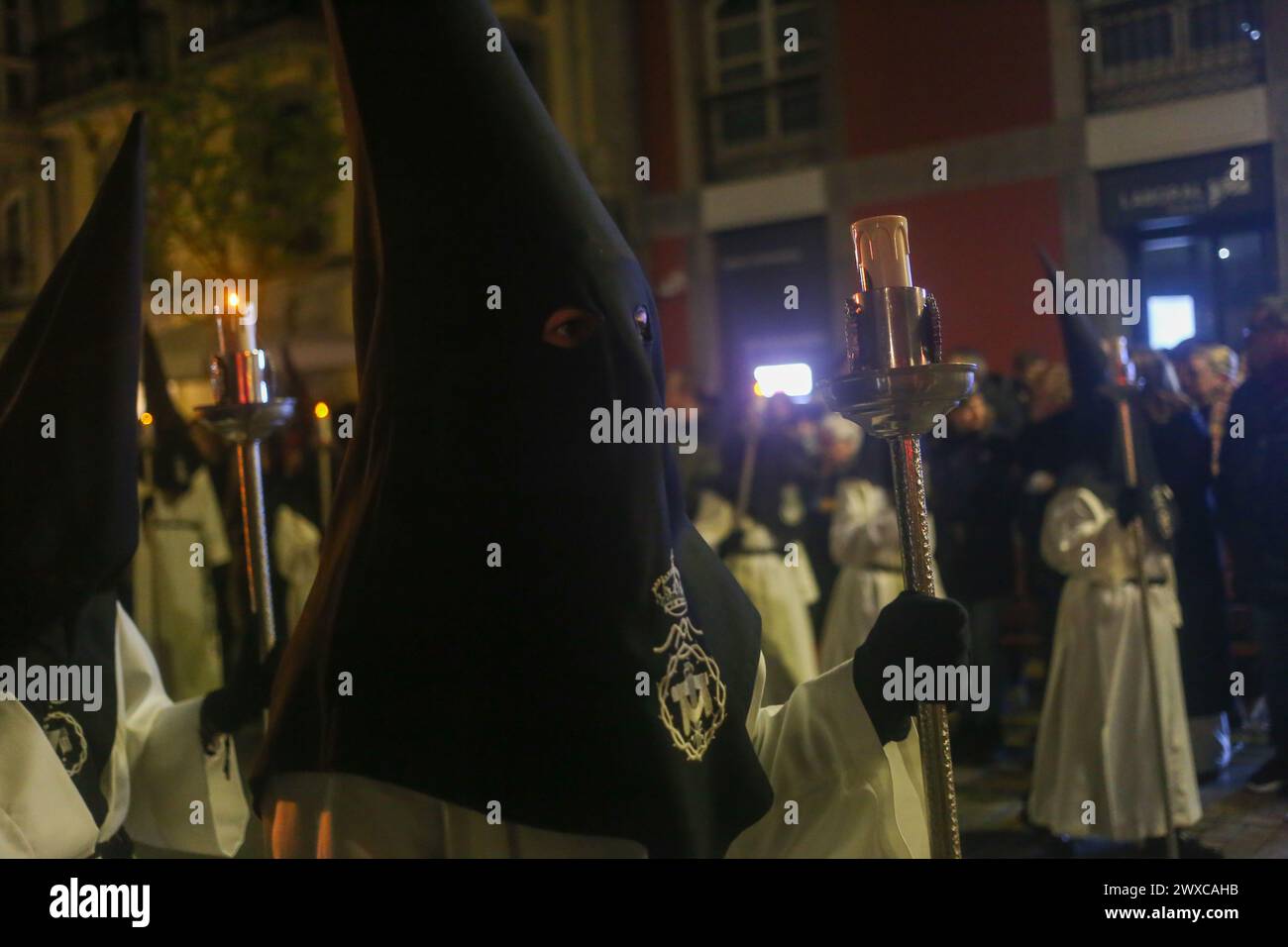 Avilés, Spain, March 29, 2024: A Nazarene carries a candle during Good Friday in Avilés, on March 29, 2024, in Avilés, Spain. Credit: Alberto Brevers / Alamy Live News. Stock Photo