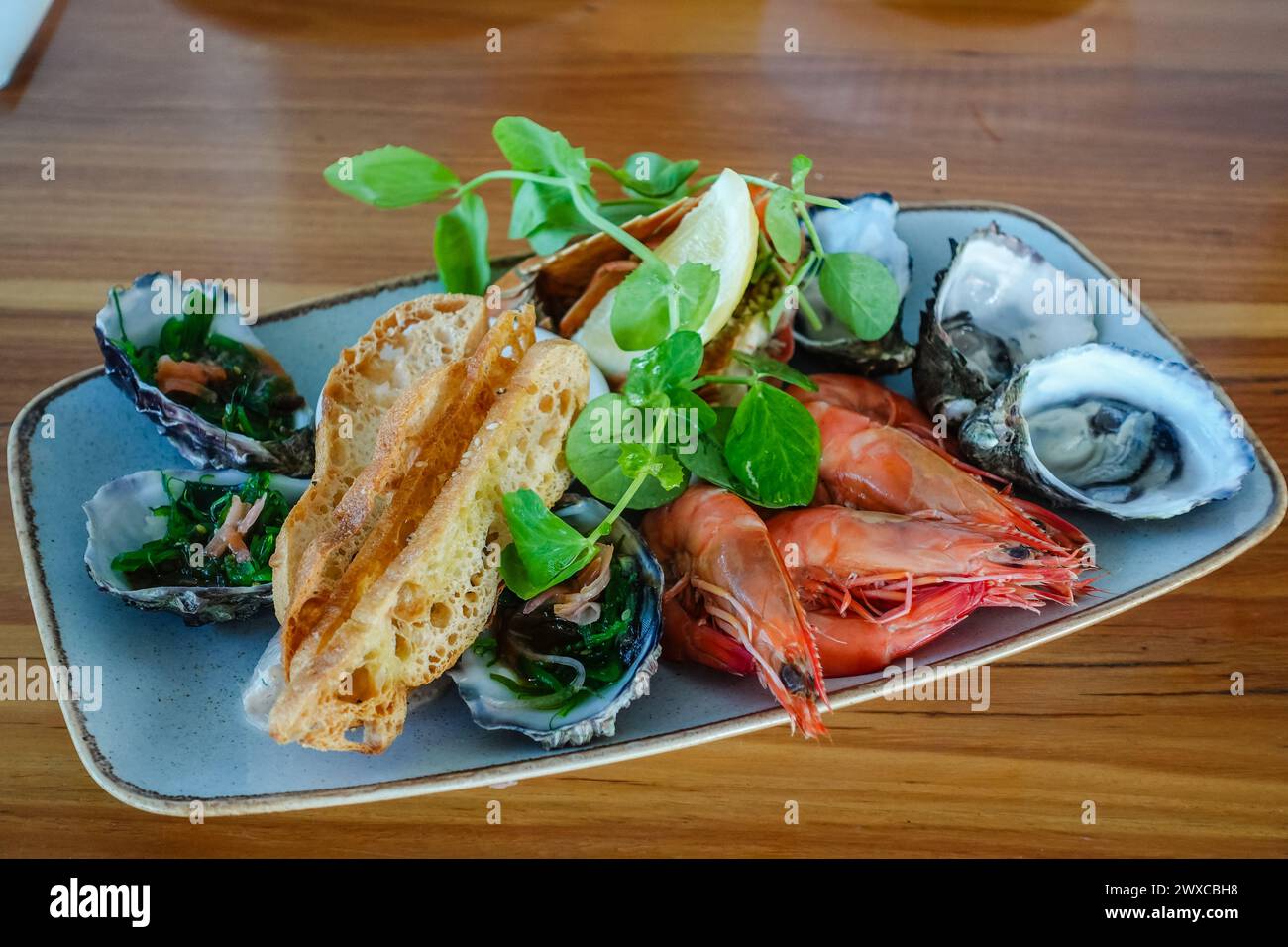 seafood appetizer consisting of oyster and shrimp typically served in a restaurant in australia Stock Photo