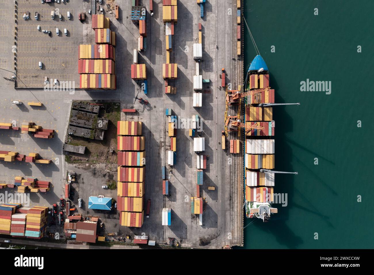 In Container Camera Shot Aerial top view of container ship being loaded at industrial port ...