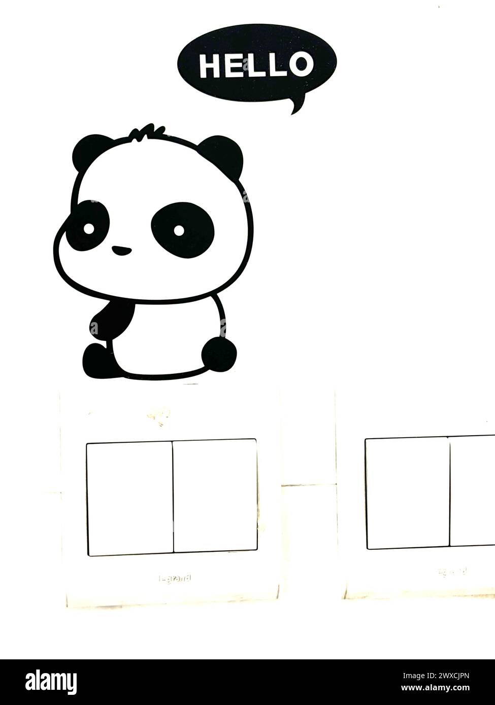Panda sticker saying hello above electric key Stock Photo