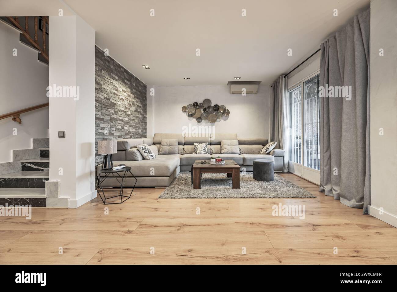 Living room with coffee table and corner sofa upholstered in gray ...