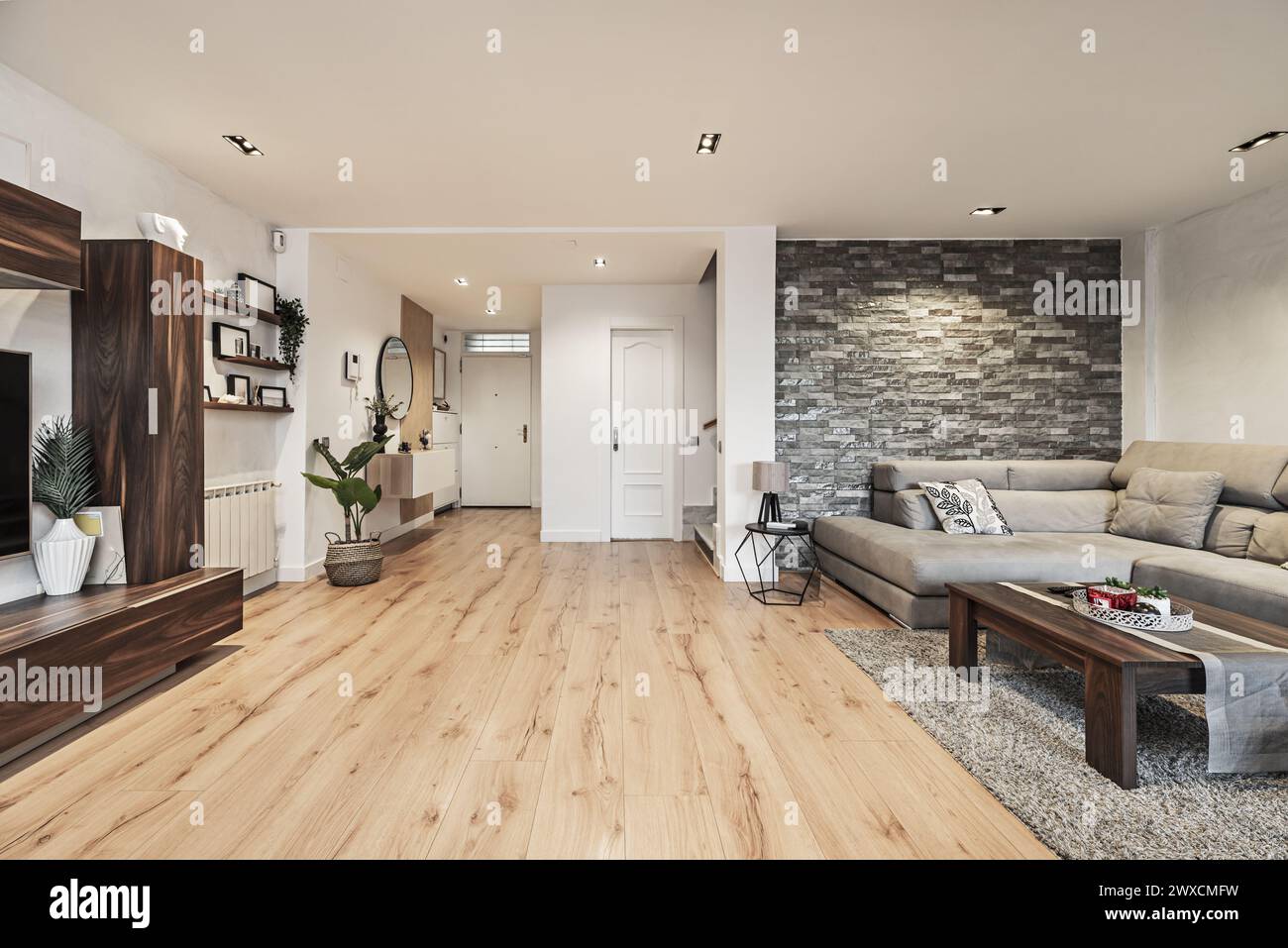 Living room with coffee table and corner sofa upholstered in gray ...
