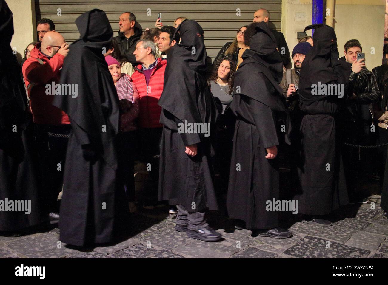Sessa Aurunca, Italy. 29th Mar, 2024. March 29, 2024, Caserta, Italy : People wear black hoods while take part during the Holy Friday procession from Church of San Giovanni to Villa. on March 29, 2024, Caserta, Italy. (Photo by Pasquale Senatore/Eyepix Group/Sipa USA) Credit: Sipa USA/Alamy Live News Stock Photo