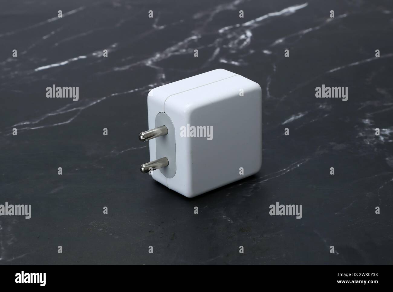 two pin smatphone white color charger isolated on black marble background Stock Photo