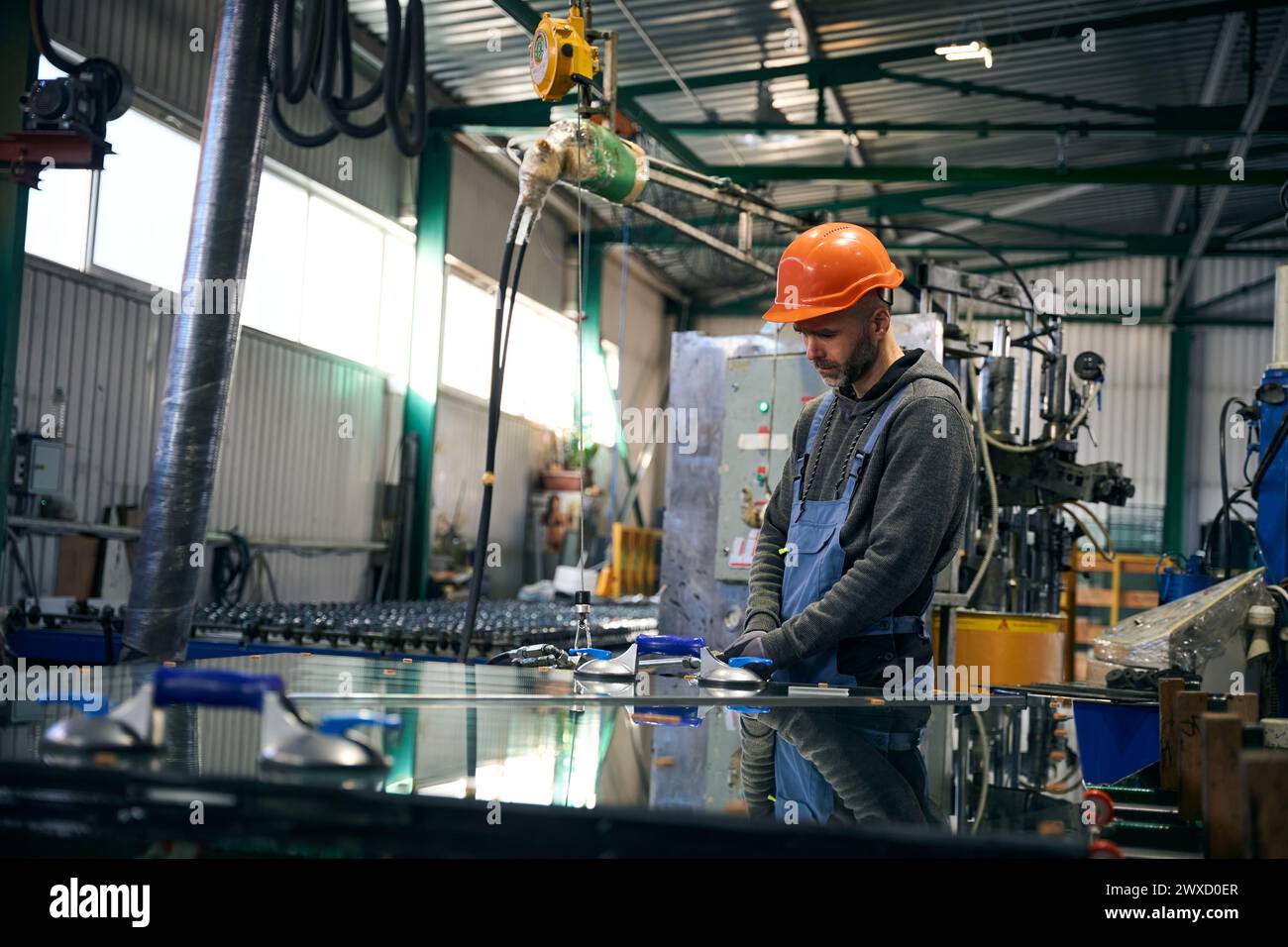 Worker uses special tools for working with glass Stock Photo