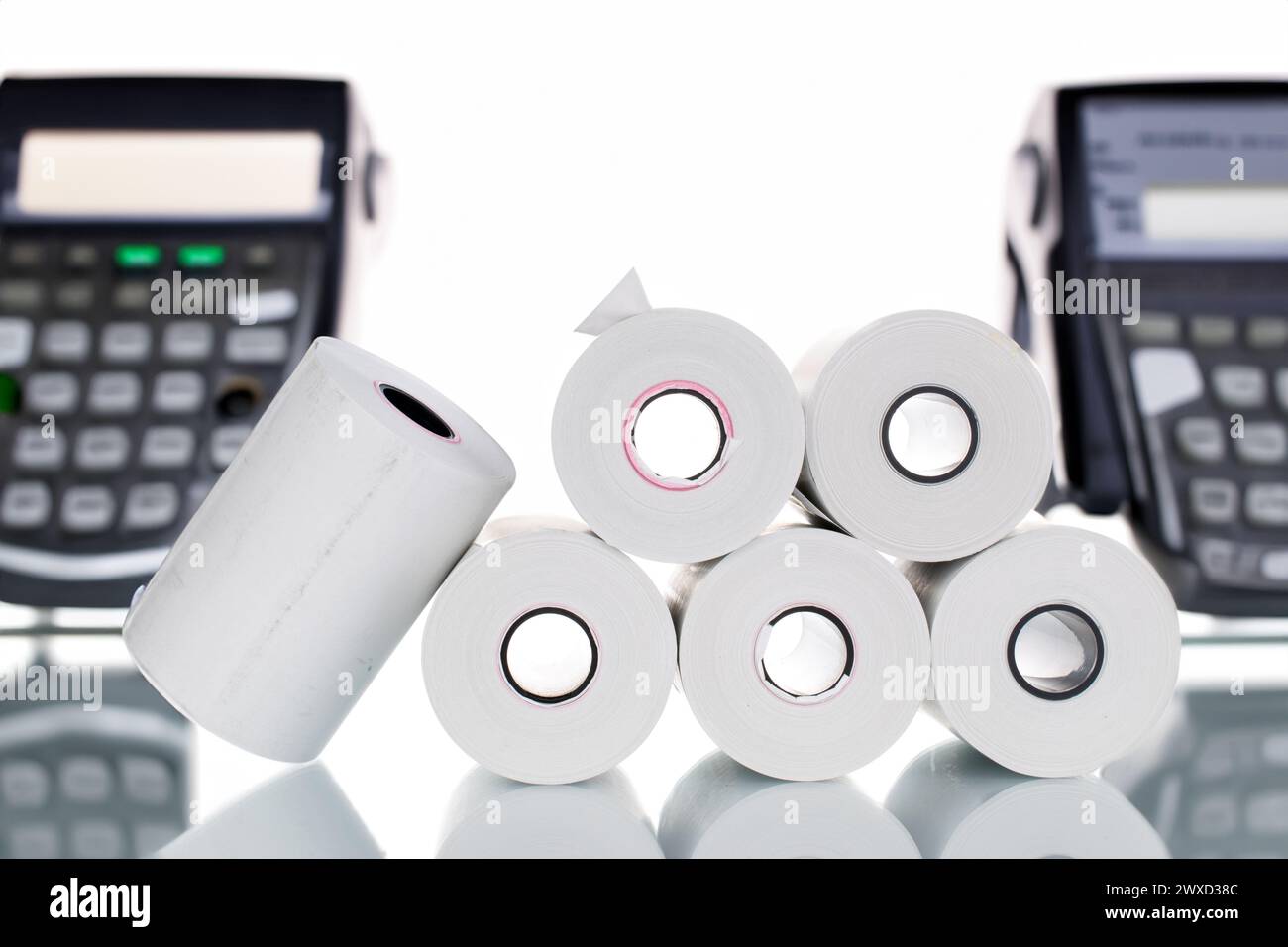 Several rolls of paper cash register tape on the background of cash