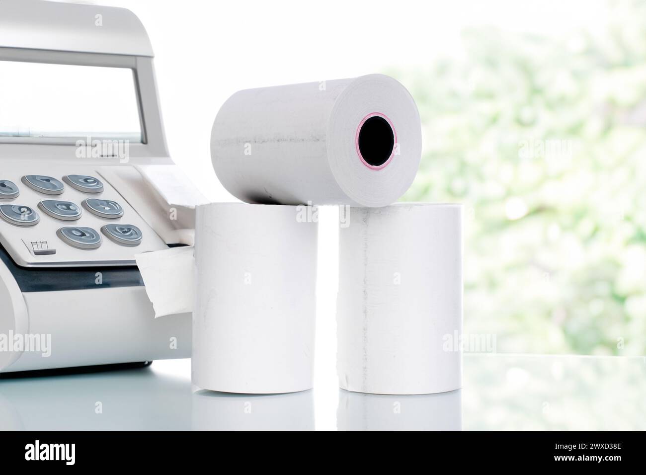 Several rolls of paper cash register tape on the background of cash