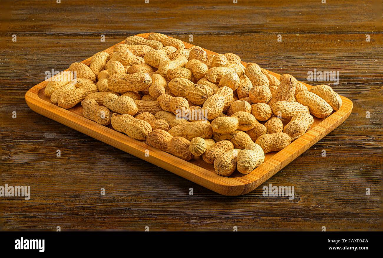 Wooden tray filled with tasty peanuts Stock Photo