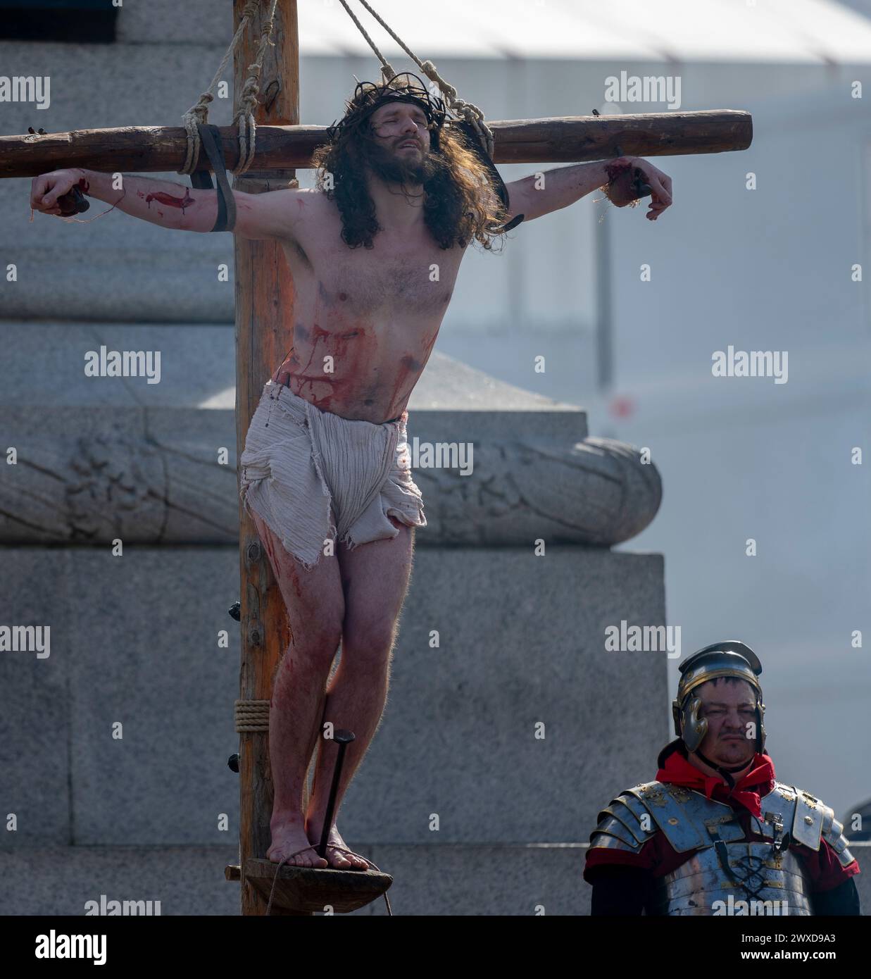 Trafalgar Square, London, UK. 29th Mar, 2024. For Good Friday 100 Wintershall players bring their moving portrayal of the final days of Jesus to Trafalgar Square in the capital in an open air production watched by thousands of spectators. Credit: Malcolm Park/Alamy Stock Photo