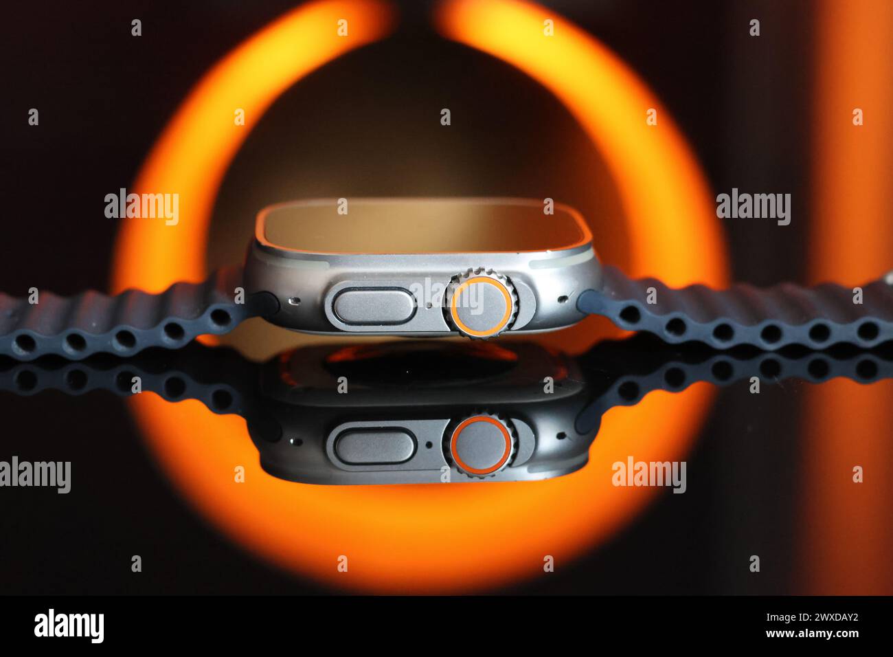 Very striking black and orange image and a Apple Watch Ultra with grey Ocean Band Stock Photo