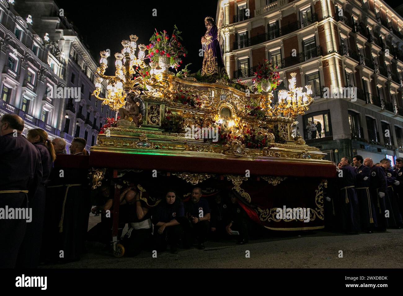 Madrid, Spain. 29th Mar, 2024. The Lord of Madrid (Cristo de Medinaceli) is carried in procession by the costaleros of the Medinaceli brotherhood through the center of Madrid on Good Friday. This Good Friday, the brotherhood of the Primary Archconfraternity of the Real and Illustrious Slavery of Nuestro Padre Jesús Nazareno de Medinaceli, popularly known as 'The Lord of Madrid, has processed like every Good Friday through the streets of the center of Madrid. (Photo by David Canales/SOPA Images/Sipa USA) Credit: Sipa USA/Alamy Live News Stock Photo