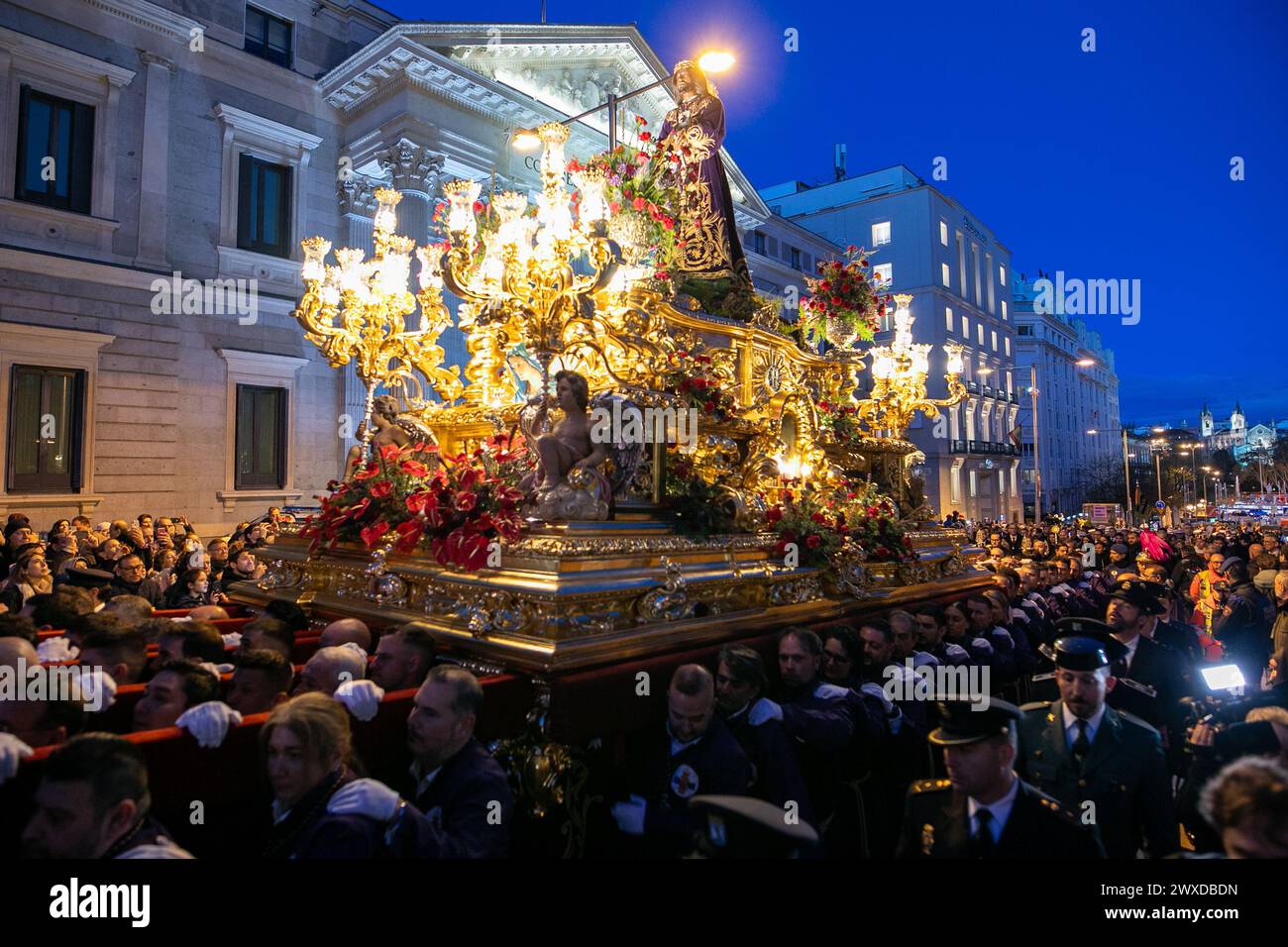 Madrid, Spain. 29th Mar, 2024. The Lord of Madrid (Cristo de Medinaceli) is carried in procession by the bearers of the Medinaceli brotherhood in front of the Congress of Deputies on Good Friday. This Good Friday, the brotherhood of the Primary Archconfraternity of the Real and Illustrious Slavery of Nuestro Padre Jesús Nazareno de Medinaceli, popularly known as 'The Lord of Madrid, has processed like every Good Friday through the streets of the center of Madrid. (Photo by David Canales/SOPA Images/Sipa USA) Credit: Sipa USA/Alamy Live News Stock Photo