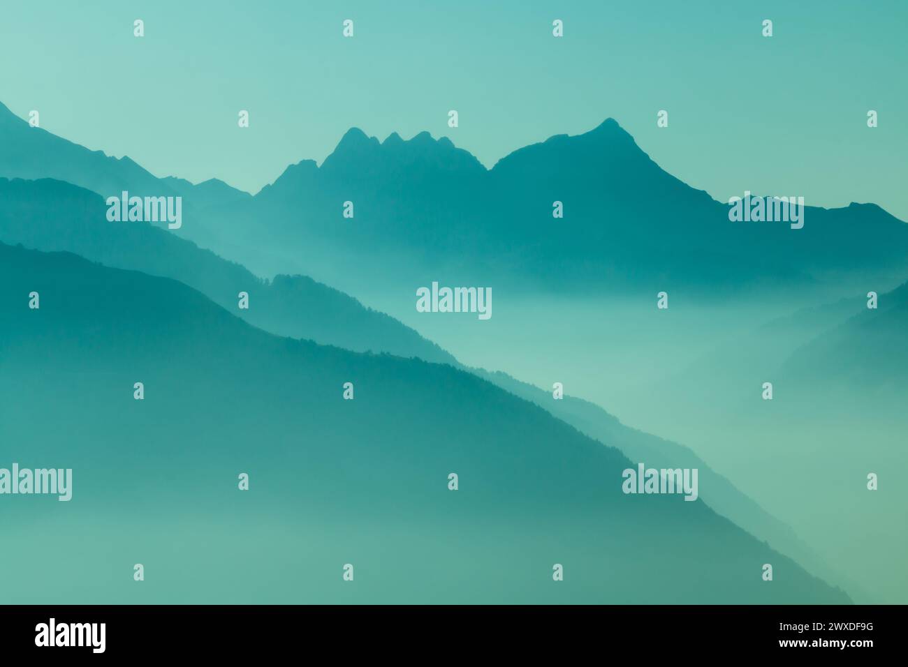 Spectacular mountain ranges silhouettes in shades of blue. Stock Photo