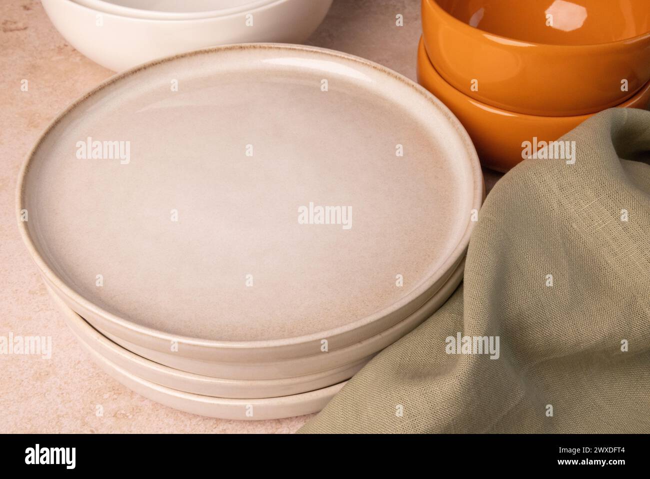 A selection of tableware on a brown stone tabletop. Stock Photo