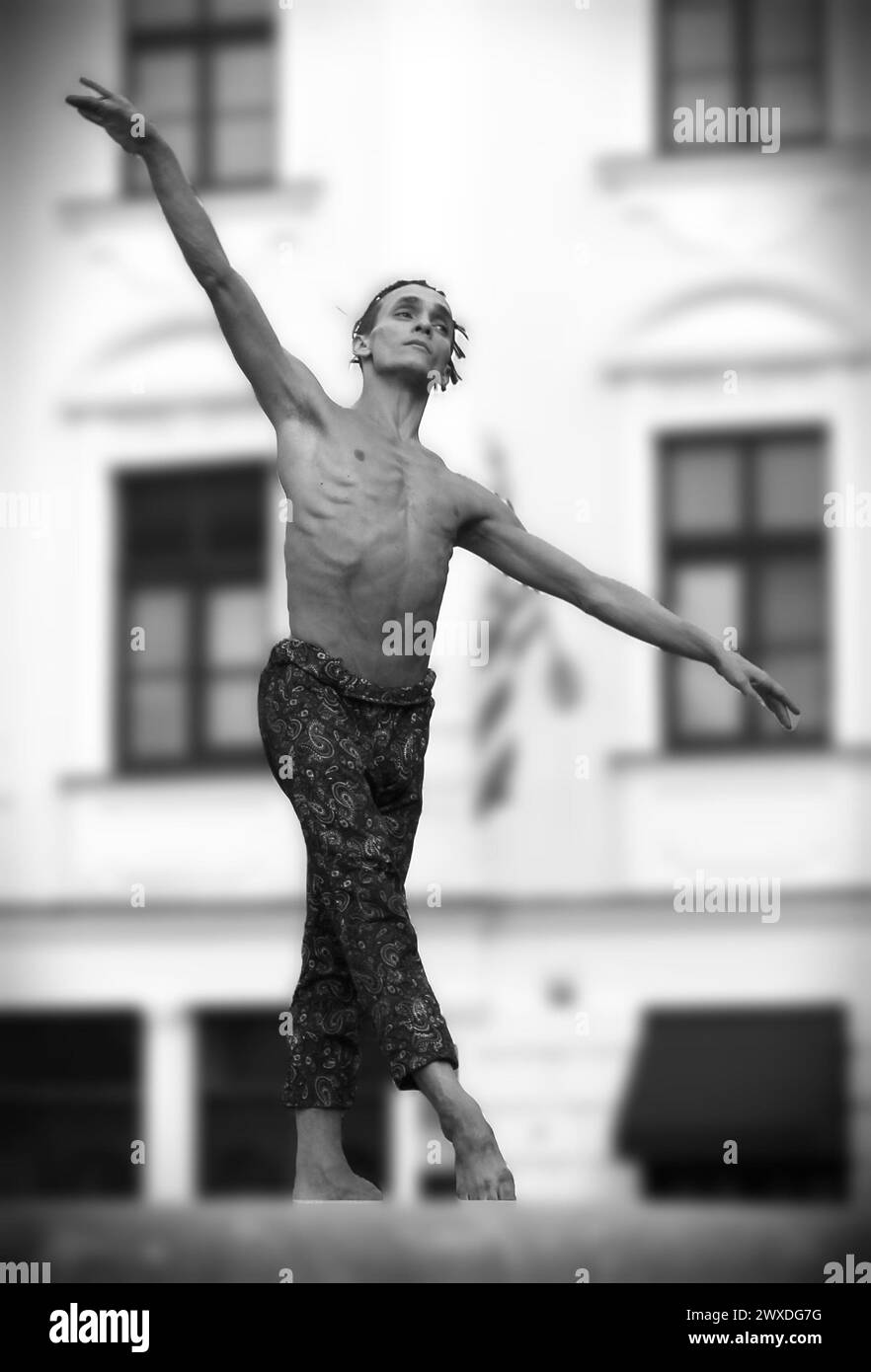 Street artist - a ballet dancer dancing on a fountain rim Stock Photo