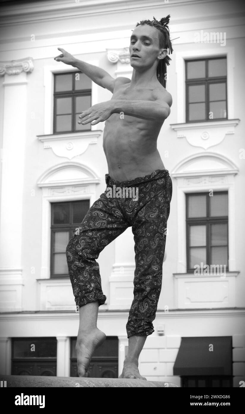 Street artist - a ballet dancer dancing on a fountain rim Stock Photo