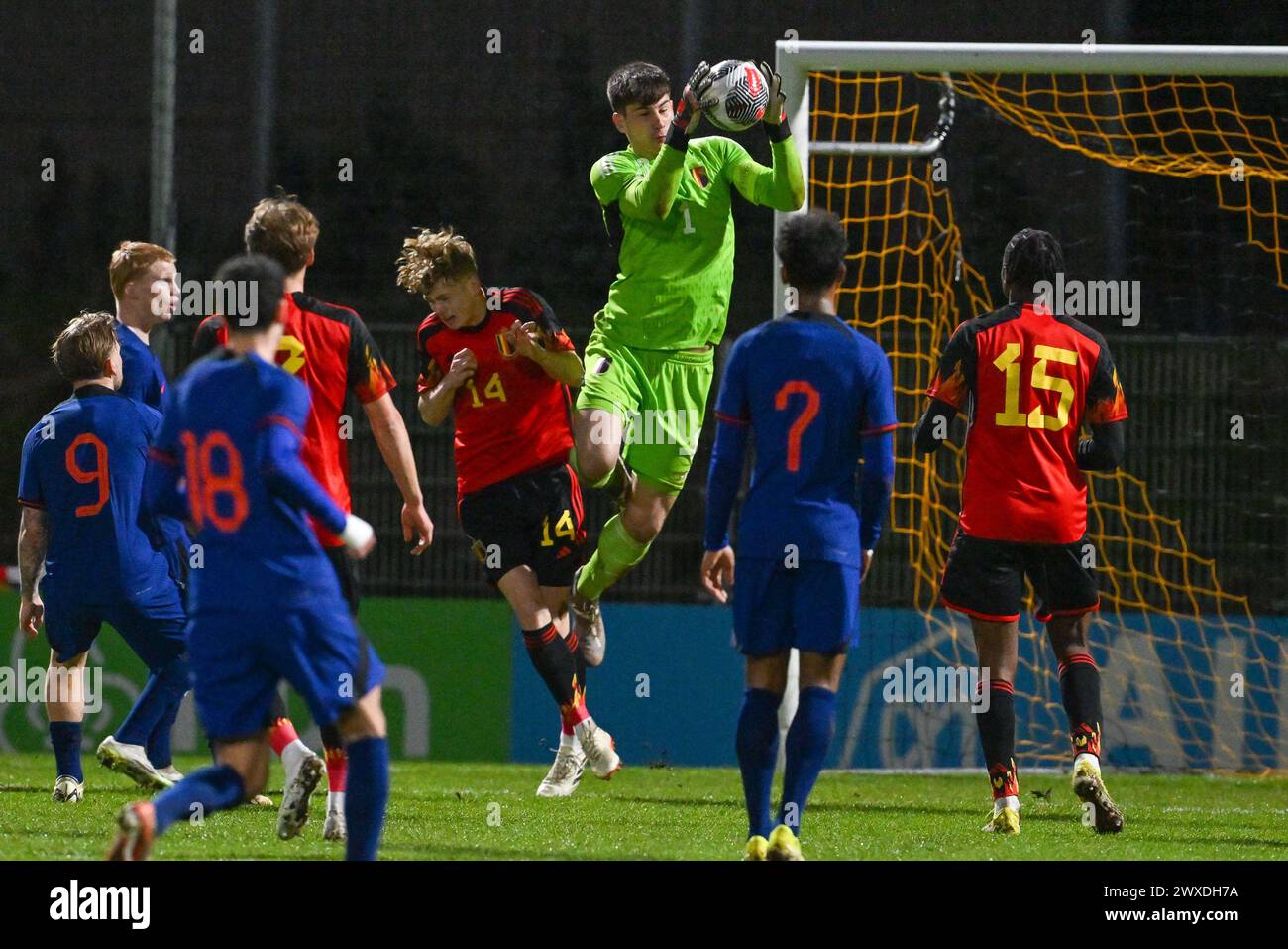 Arthur Piedfort (14) of Belgium and goalkeeper Mike Penders (1) of Belgium pictured in action during a soccer game between the national under 19 teams of Belgium and The Netherlands on matchday 3 in group 2 of the UEFA Under-19 Elite round on Thursday 26 March 2024  in Veendam , The Netherlands . PHOTO SPORTPIX | David Catry Stock Photo