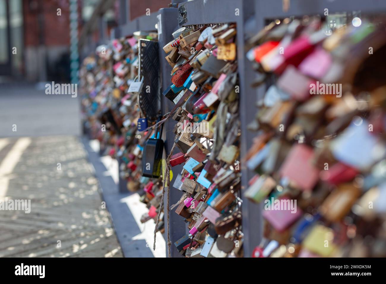 Love lock bridge at Katajanokka with many locks. Couples putting locks on bridges. Bridge full of locks. Vertical photos. Stock Photo