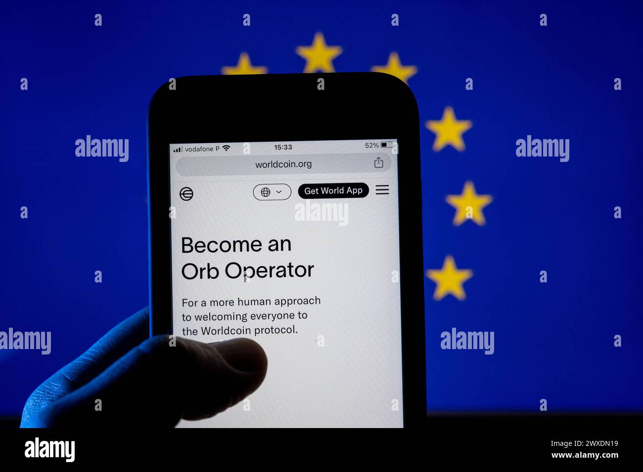 Azores, Portugal - 29.03.2024: Smartphone screen with WorldCoin  - Human identity -webpage with European flag on the background. Stock Photo