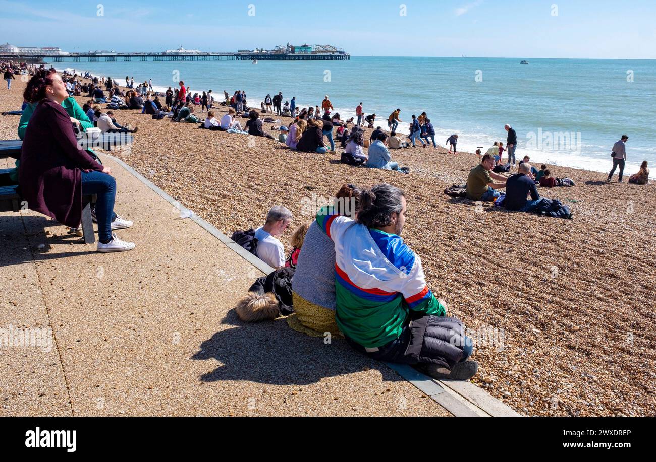 Brighton UK 30th March 2024 - Visitors enjoy a beautiful warm sunny day on Brighton beach and seafront with more sunshine forecast for Easter Sunday tomorrow : Credit Simon Dack / Alamy Live News Stock Photo