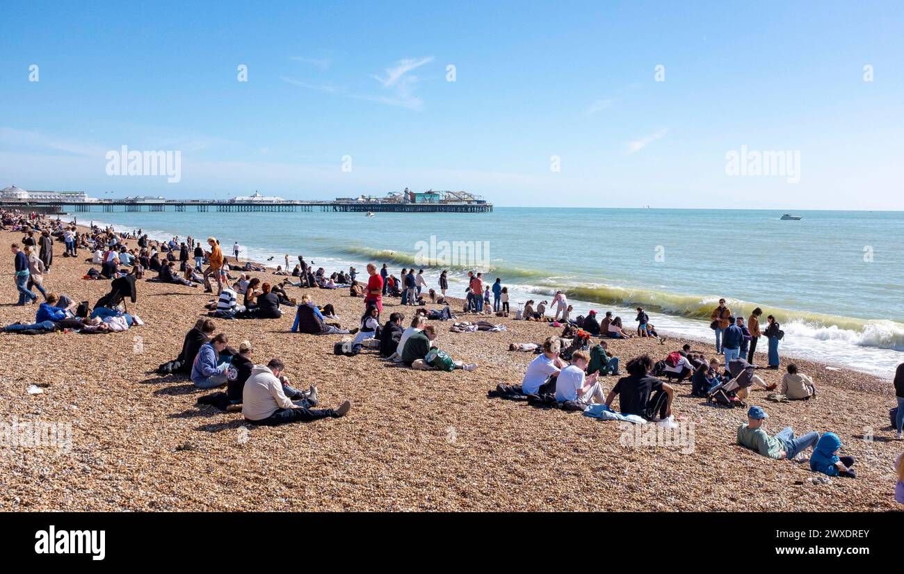 Brighton UK 30th March 2024 - Visitors enjoy a beautiful warm sunny day on Brighton beach and seafront with more sunshine forecast for Easter Sunday tomorrow : Credit Simon Dack / Alamy Live News Stock Photo