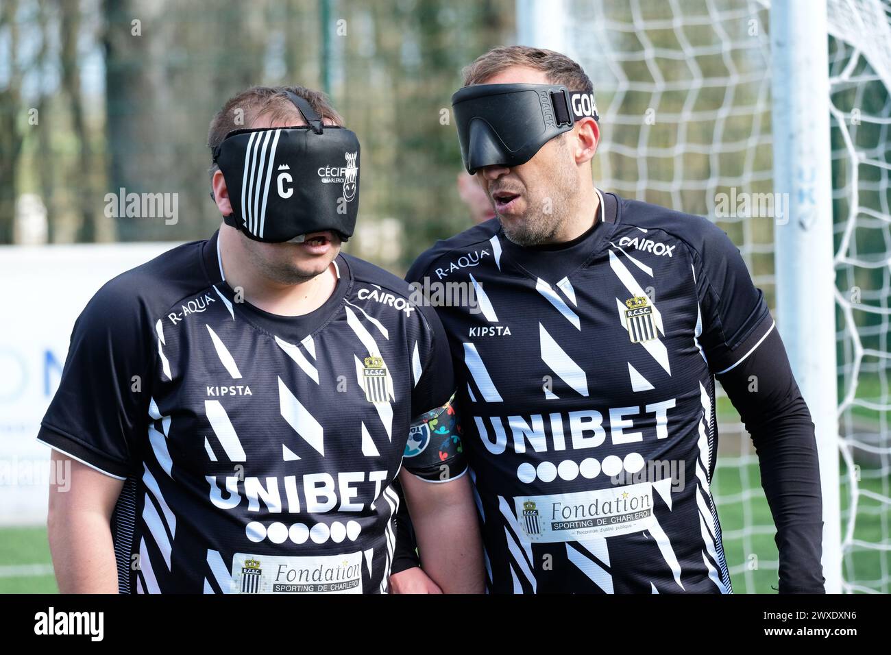 Royal National College for the Blind, Hereford, UK – Saturday 30th March 2024 – Round 3 of the European Blind Football League ( EBFL ) held at the Royal National College for the Blind at Hereford. All players wear eye masks to ensure fairness between those blind and those partially sighted. Players from Belgian team Cecifoot Charleroi talk whilst defending a free kick.  Photo Steven May / Alamy Live News Stock Photo