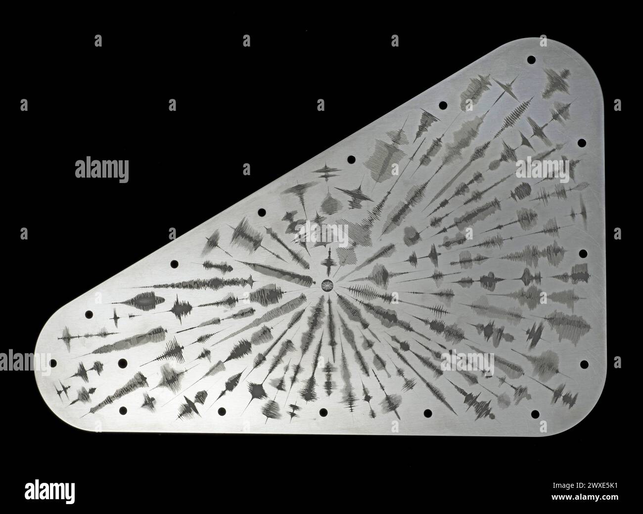 In October 2024, NASA's Europa Clipper will launch, bearing a special message bound for Jupiter's moon Europa. The moon holds evidence of an immense subsurface ocean. A tantalum metal plate measuring 18x28 cm, will be engraved with waveforms representing 'water' in 103 languages, symbolizing Earth's connection to Europa. This gesture of sending a message into space engraved on a metal disk parallels that of the golden metal discs sent on the Voyager spacecraft launched in 1977.  Optimised version of an original NASA image / Credit:  NASA/JPL Stock Photo