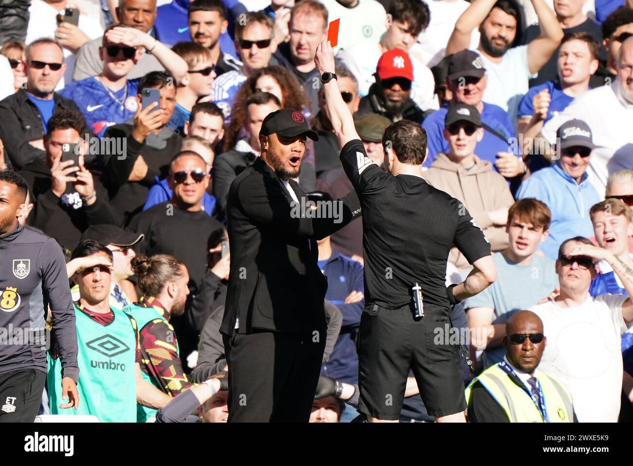 Burnley manager Vincent Kompany is shown a red card by referee Darren England during the Premier League match at Stamford Bridge, London. Picture date: Saturday March 30, 2024. Stock Photo