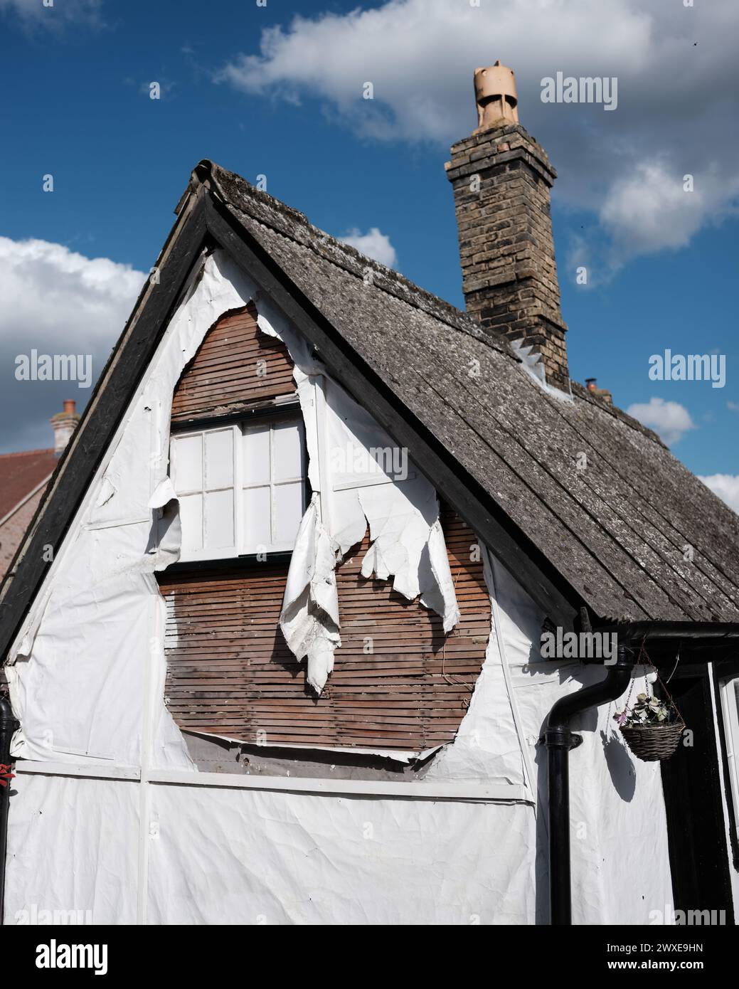 Peeling plaster on a small house Stock Photo