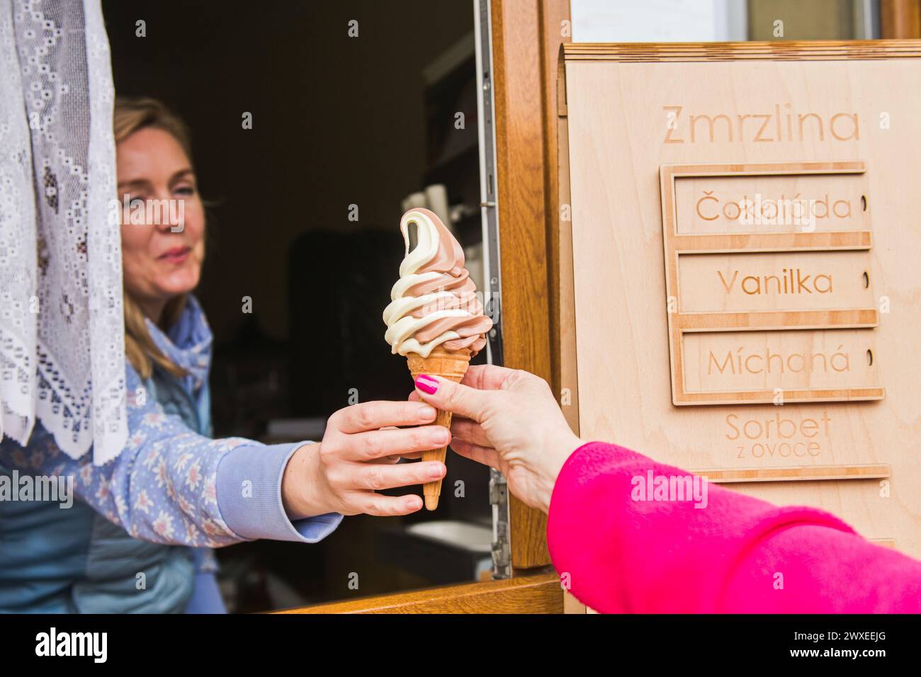 Zbysov, Czech Republic. 30th Mar, 2024. Woman selling ice cream on a warm spring day, March 30, 2024, Zbysov, Brno district, South Moravian Region. Credit: Patrik Uhlir/CTK Photo/Alamy Live News Stock Photo