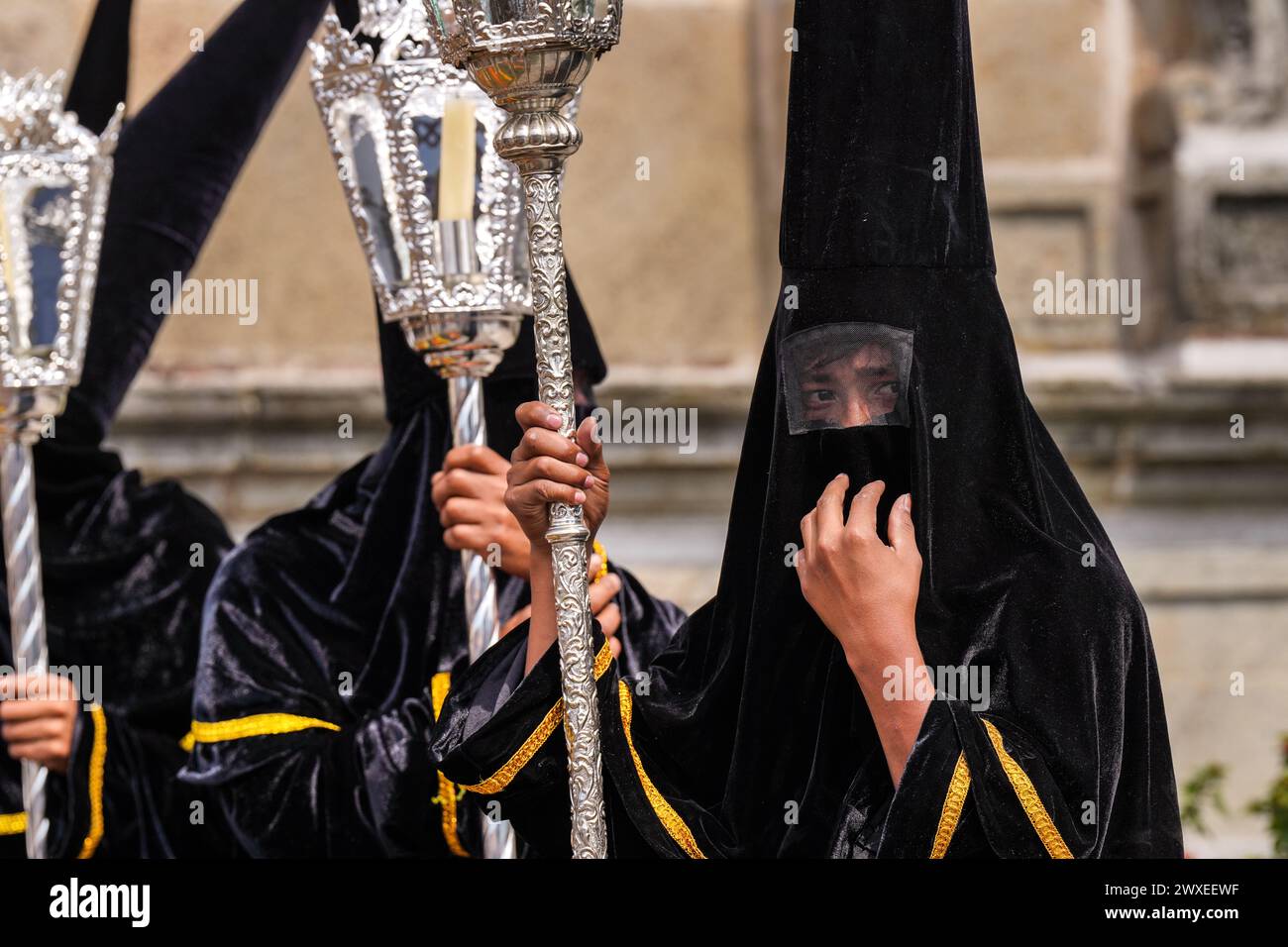 Antigua, Guatemala. 29th Mar, 2024. A confraternity of penitents, wearing capirote hats, wait outside the Escuela de Cristo church for the start of the Senor Sepultado Good Friday procession during Semana Santa, March 29, 2024 in Antigua, Guatemala. The opulent procession is one of the largest in the world involving thousands of devotees and lasting 12-hours. Credit: Richard Ellis/Richard Ellis/Alamy Live News Stock Photo