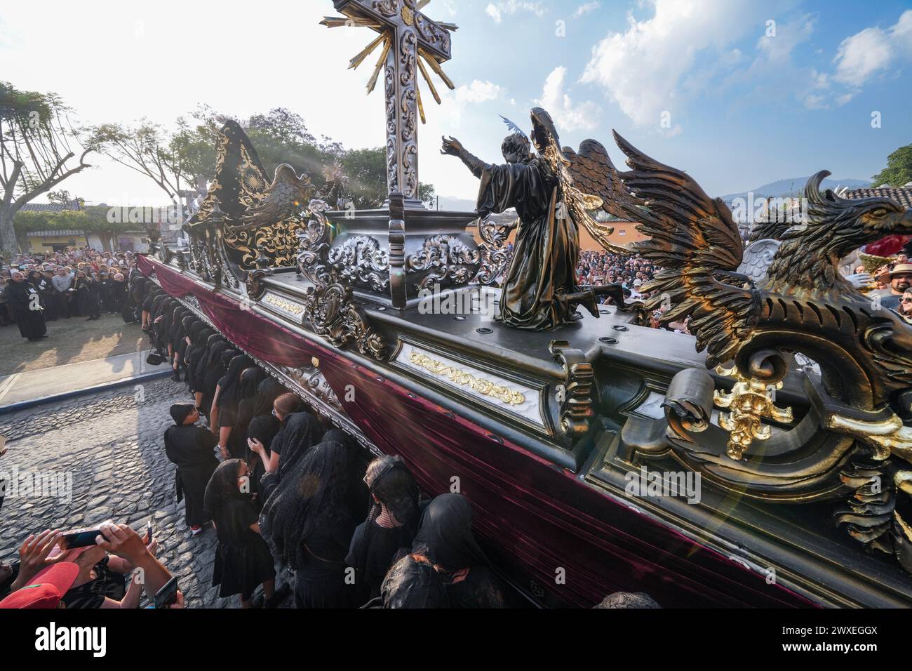 Antigua, Guatemala. 29th Mar, 2024. A massive processional float of the grieving Virgin Mary is carried from the Escuela de Cristo church at the start of the Good Friday procession during Semana Santa, March 29, 2024 in Antigua, Guatemala. The opulent procession is one of the largest in the world requiring over 100 people to carry the float which takes 12-hours to complete the procession. Credit: Richard Ellis/Richard Ellis/Alamy Live News Stock Photo