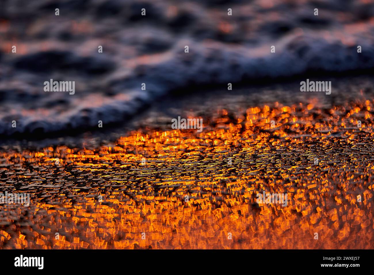 Gilded Ripples Dance Upon Molten Waters Stock Photo