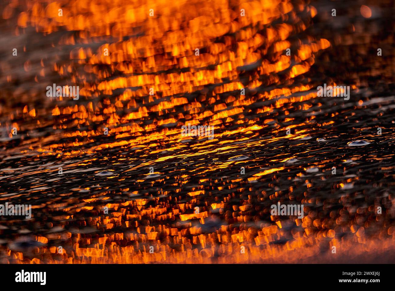 Gilded Ripples Dance Upon Molten Waters Stock Photo