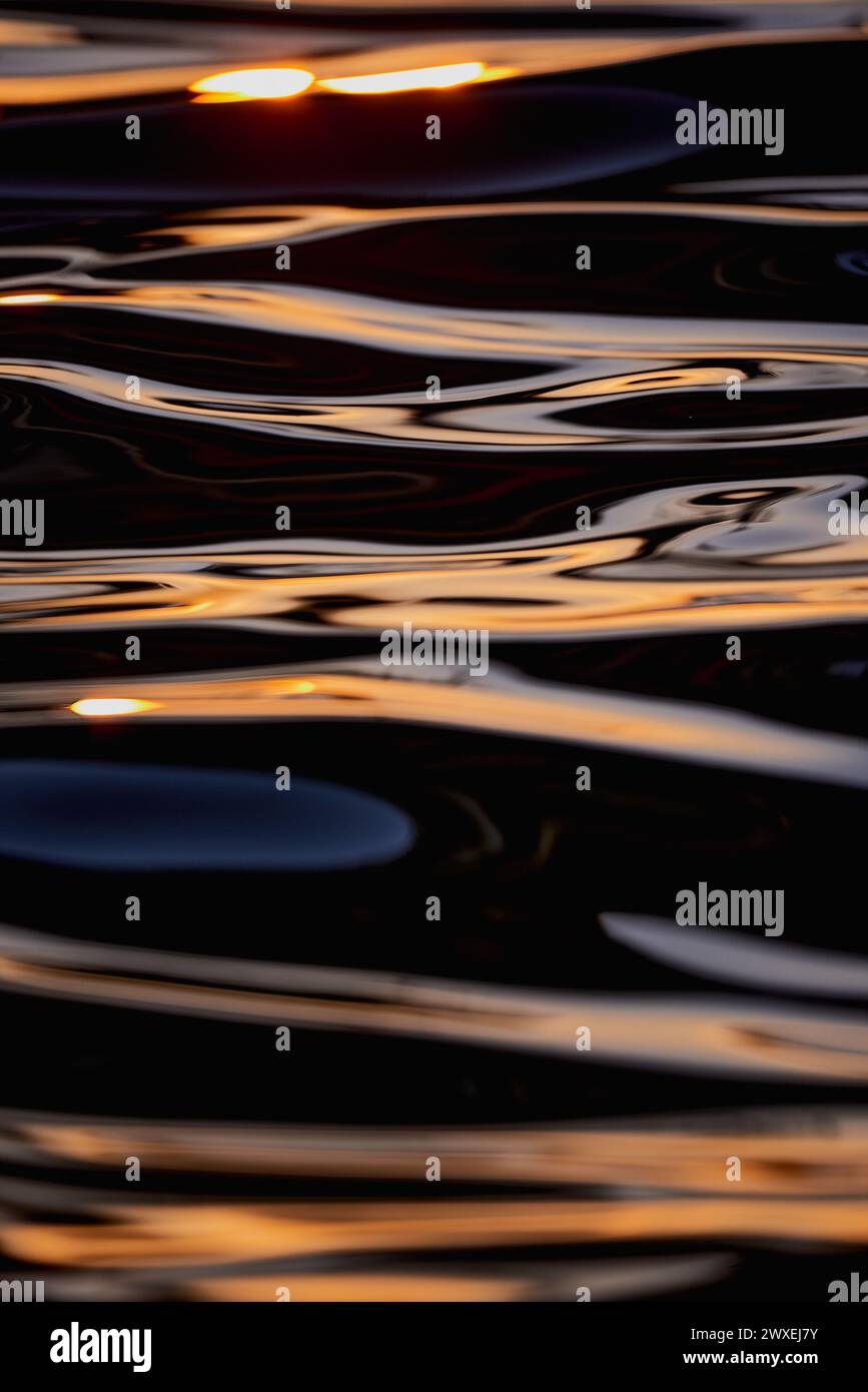Gilded Ripples Dance Upon Molten Waters Stock Photo