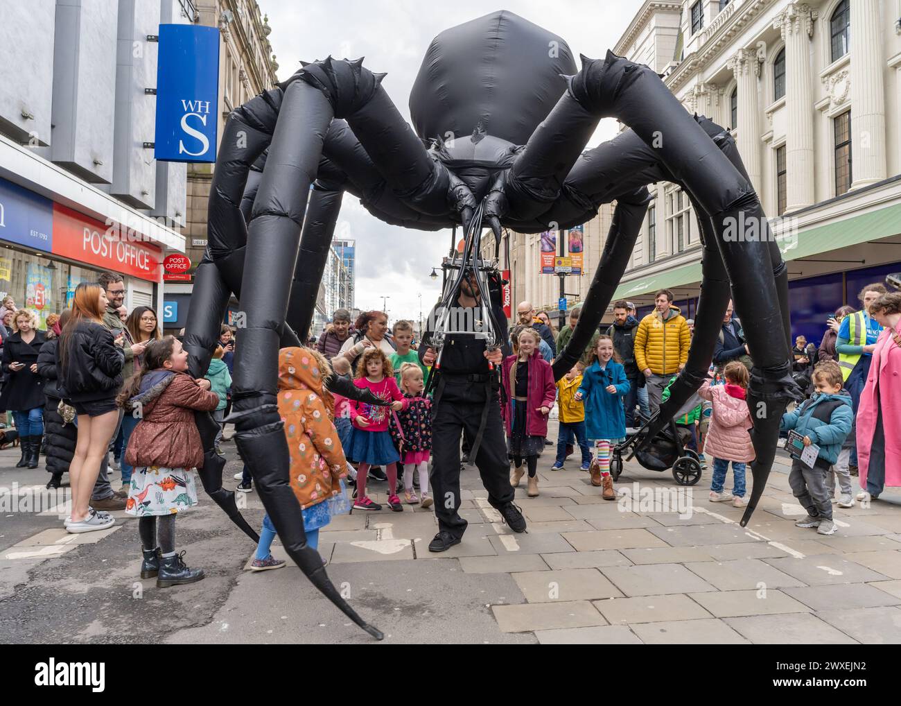 Newcastle upon Tyne, UK. 30th March 2024. Beasts on the Street, puppet performances on Northumberland Street in the city, as Newcastle Puppetry Festival is launched. The festival runs until 7th April. -- Pictured: Arachnobot the giant spider by Tim Davies Design. Credit: Hazel Plater/Alamy Live News Stock Photo