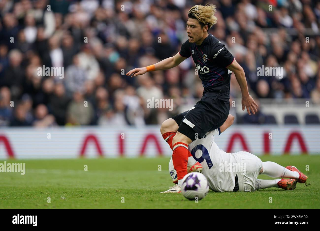 LONDON, ENGLAND - MARCH 30: Daiki Hashioka of Luton Town tackling Richarlison of Tottenham Hotspur during the Premier League match between Tottenham Hotspur and Luton Town at Tottenham Hotspur Stadium on March 30, 2024 in London, England.(Photo by Dylan Hepworth/MB Media) Stock Photo