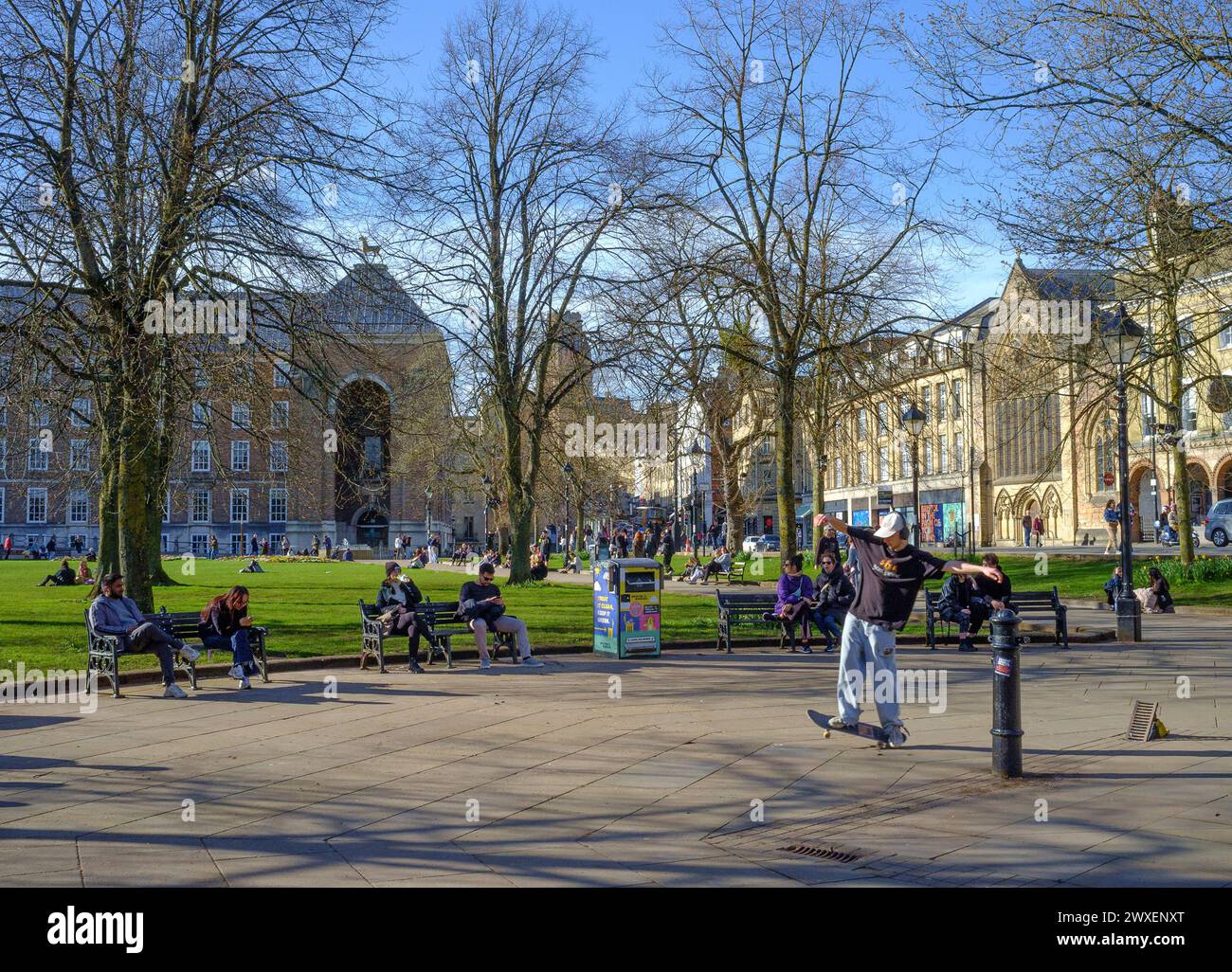 After months of rain, an afternoon of sun brings people to College Green to sit and enjoy. Others on skateboards. Stock Photo