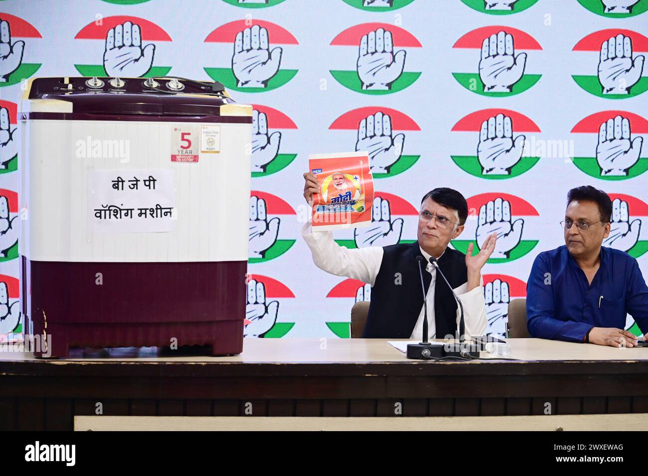 NEW DELHI, INDIA - MARCH 30: Congress leader Pawan Khera showing ‘Modi Washing Powder' and ‘Washing Machine' who cleans all corrupt Politicians and wash all charges levels against them if they Join BJP, during a press briefing at AICC, on March 30, 2024 in New Delhi, India. The Congress raised the issue of leaders, against whom there have been corruption charges, joining or aligning with the BJP only to see “the cases against them being closed”, an allegation often leveled by opposition parties. (Photo by Vipin Kumar/Hindustan Times/Sipa USA ) Stock Photo