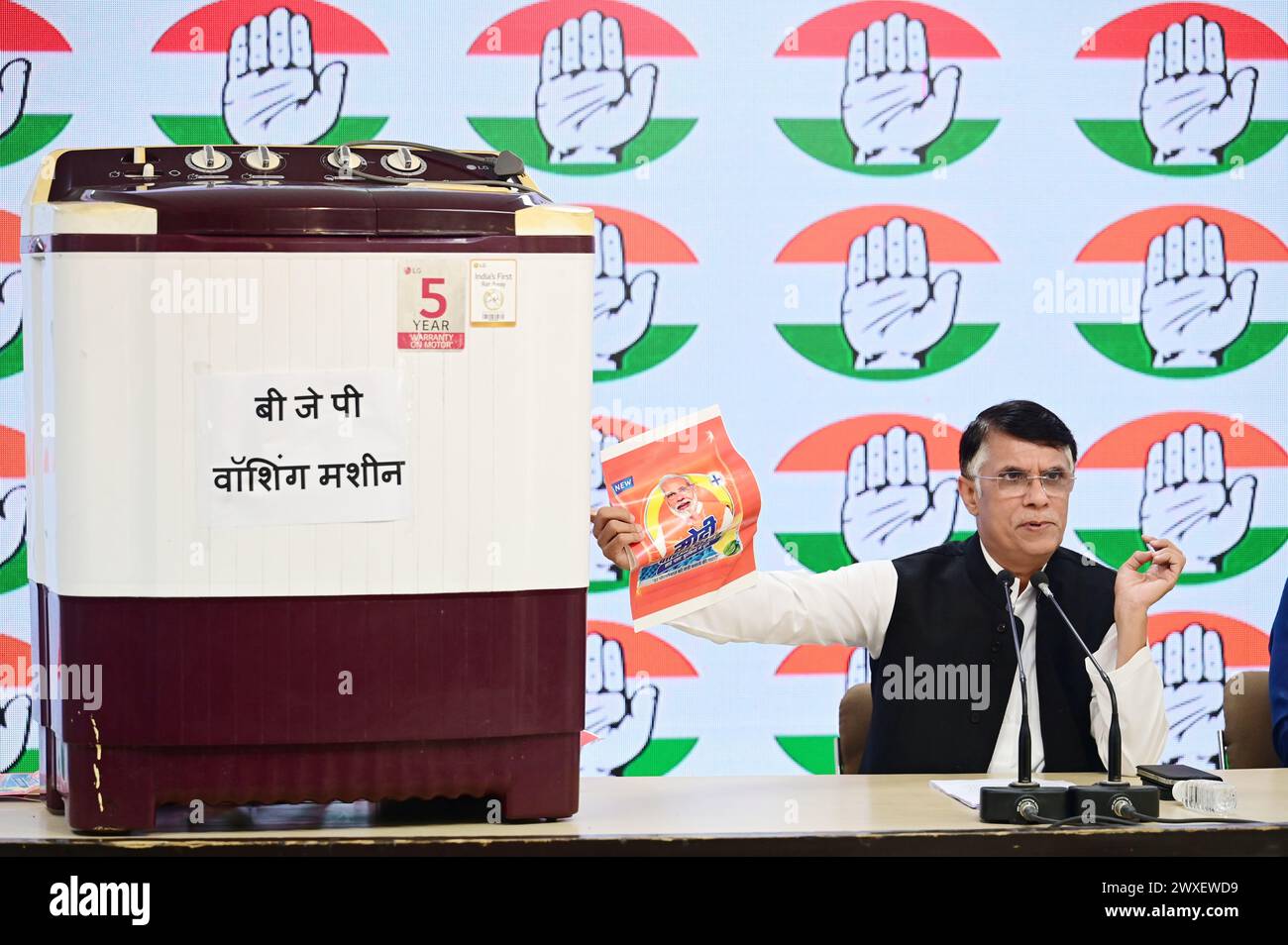 NEW DELHI, INDIA - MARCH 30: Congress leader Pawan Khera showing ‘Modi Washing Powder' and ‘Washing Machine' who cleans all corrupt Politicians and wash all charges levels against them if they Join BJP, during a press briefing at AICC, on March 30, 2024 in New Delhi, India. The Congress raised the issue of leaders, against whom there have been corruption charges, joining or aligning with the BJP only to see “the cases against them being closed”, an allegation often leveled by opposition parties. (Photo by Vipin Kumar/Hindustan Times/Sipa USA ) Stock Photo