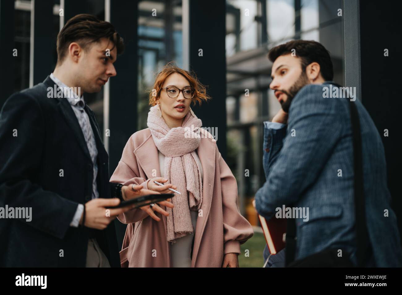 Business colleagues collaborating on a project outdoors Stock Photo