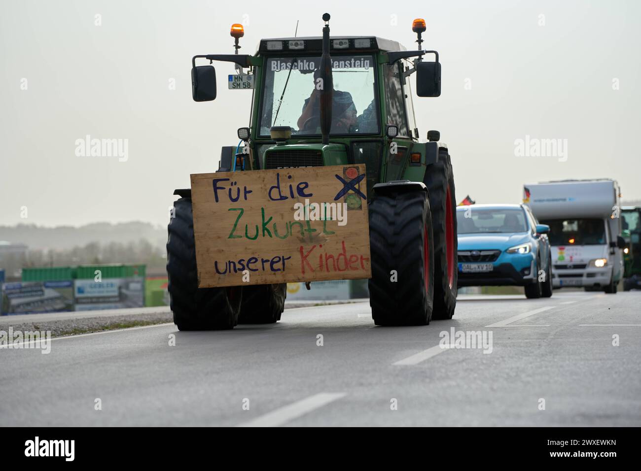 Türkheim / Bad Wörishofen, Bavaria, Germany - March 30, 2024: Easter weekend demonstration of tractors and cars against the traffic light government s policy. Posters on tractors and vehicles on the country road in Unterallgäu between Türkheim and Bad Wörishofen *** Demonstrationszug am Osterwochenende aus Traktoren und Autos gegen die Politik der Ampel-Regierung. Plakate an Traktoren und Fahrzeugen auf der Landstraße im Unterallgäu zwischen Türkheim und Bad Wörishofen Stock Photo