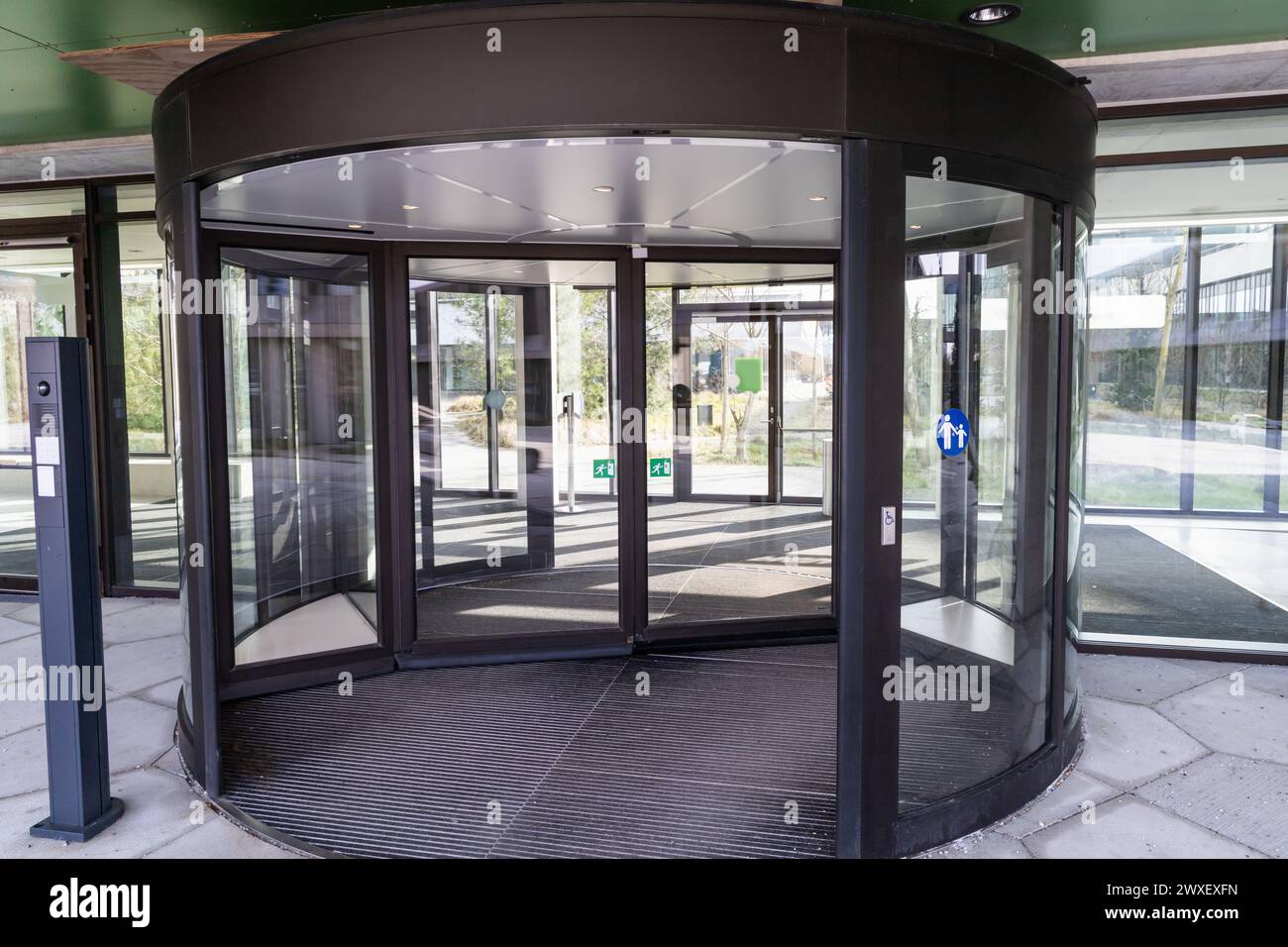 Modern entrance with revolving door. Entrance to a building and glass door. Stock Photo