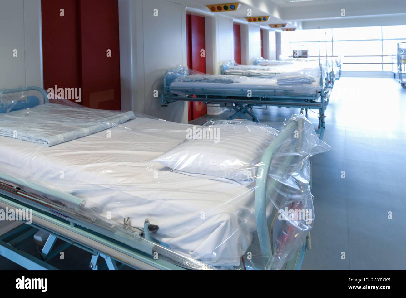 Clean hospital beds covered with film, ready for new patients. Hospital