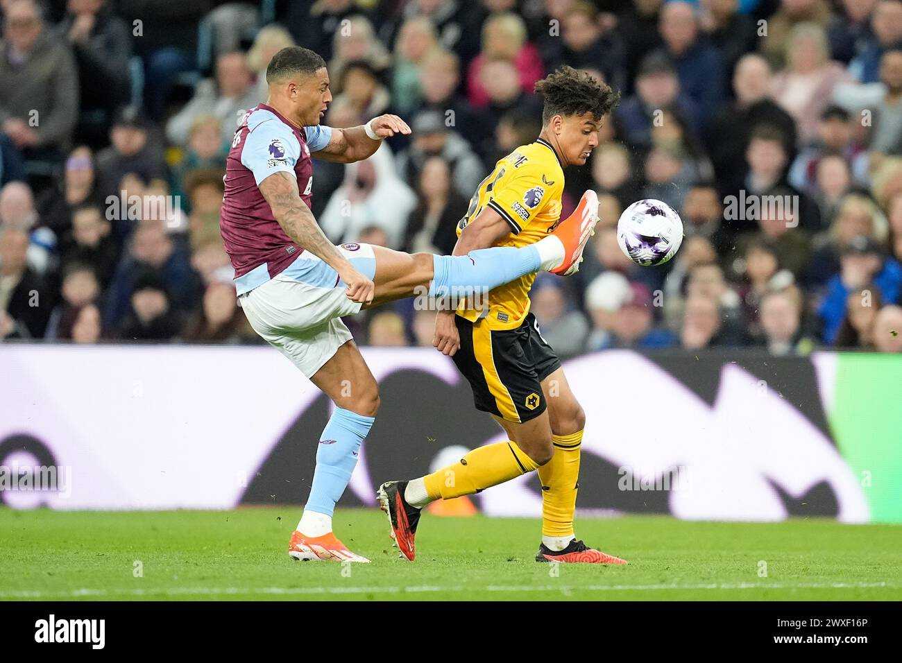 Aston Villa's Diego Carlos (left) and Wolverhampton Wanderers' Leon Chiwome battle for the ball during the Premier League match at Villa Park, Birmingham. Picture date: Saturday March 30, 2024. Stock Photo