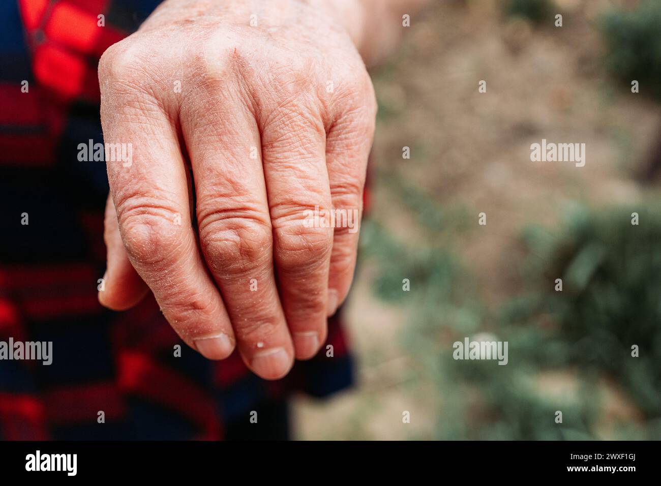 Elderly woman showing her hand. Older people Stock Photo