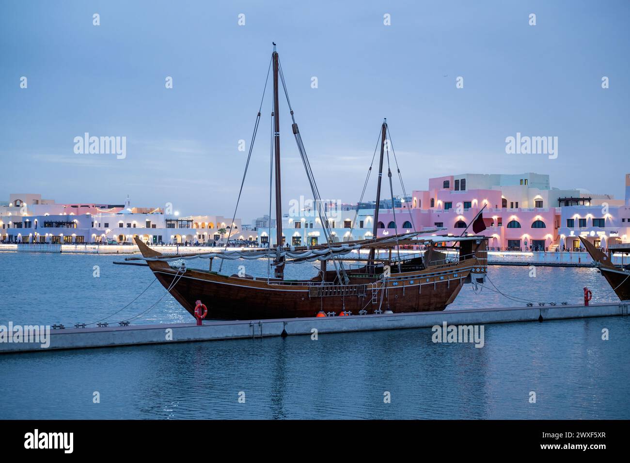 Traditional Dhow boat anchored in the Mina Port known as old Doha port ...